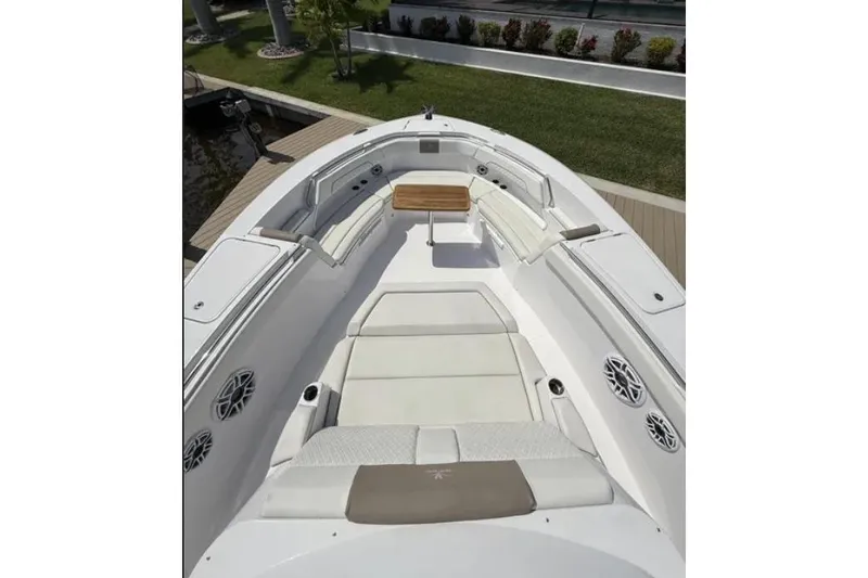  Yacht Photos Pics 2024 Bertram 39 CC boat interior with white seating and wooden table.