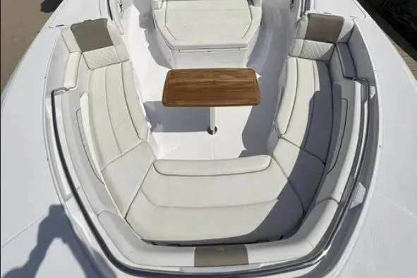  Yacht Photos Pics 2024 Bertram 39 CC boat interior with white seating and wooden table.
