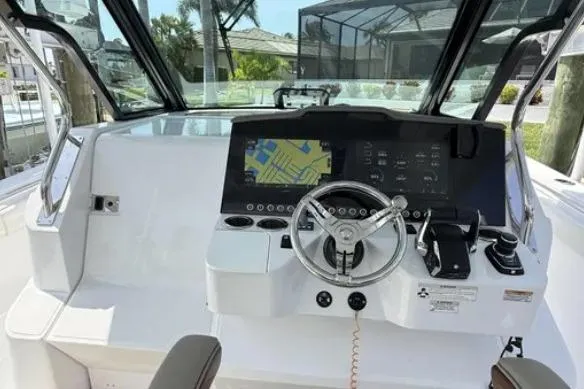  Yacht Photos Pics 2024 Bertram 39 CC boat helm with modern navigation system and steering wheel.