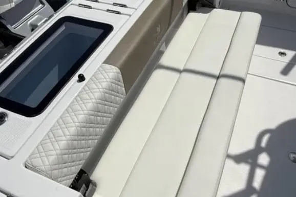  Yacht Photos Pics 2024 Bertram 39 CC boat interior with white cushioned seating and quilted accents.