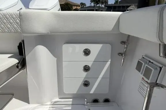  Yacht Photos Pics 2024 Bertram 39 CC boat interior with white seating and storage compartments.