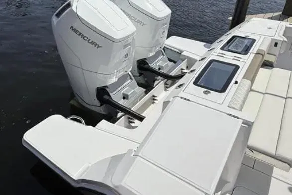  Yacht Photos Pics 2024 Bertram 39 CC boat with dual Mercury outboard engines, docked on water.