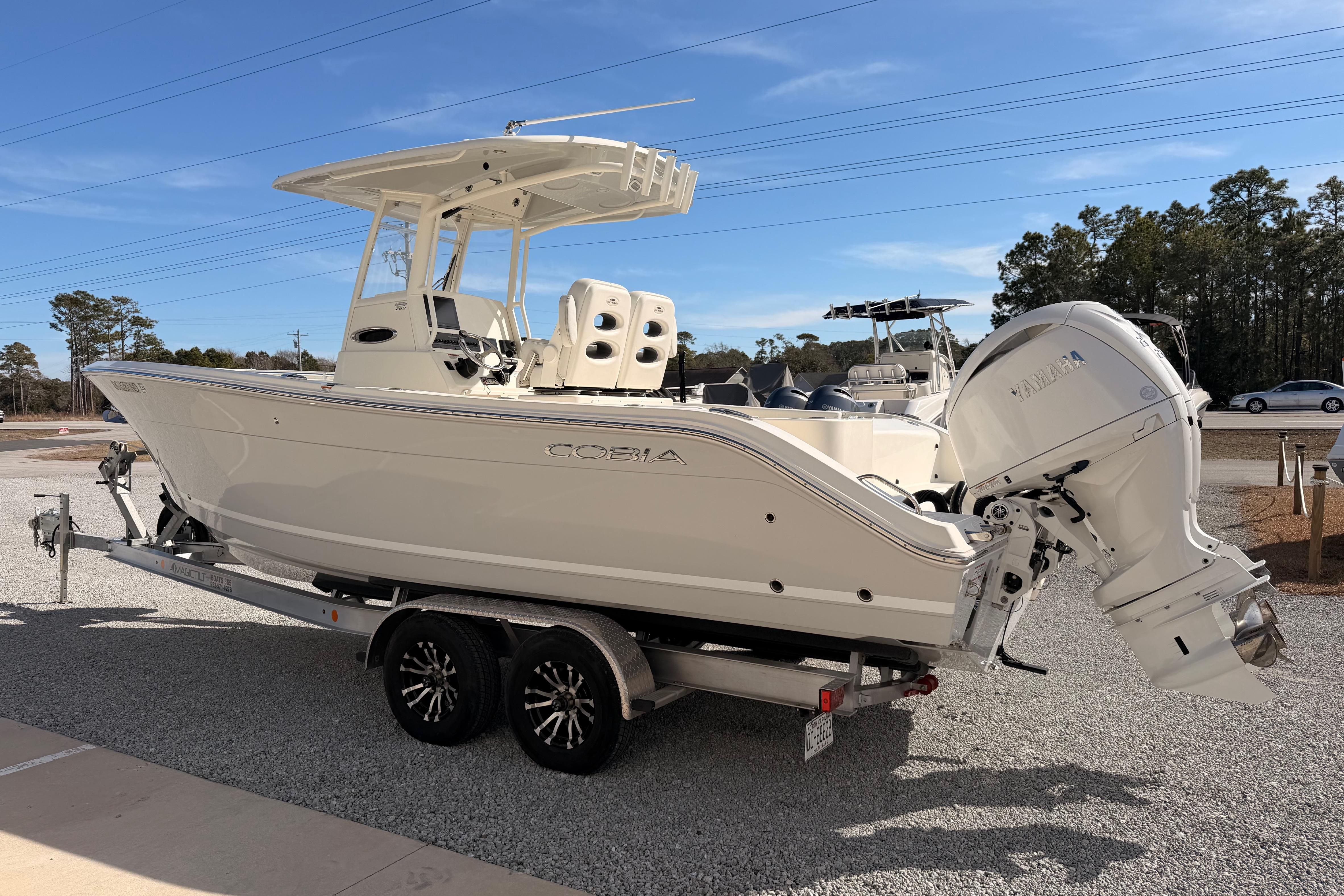 2024 Cobia 262 Center Console boat on trailer, featuring dual outboard engines.