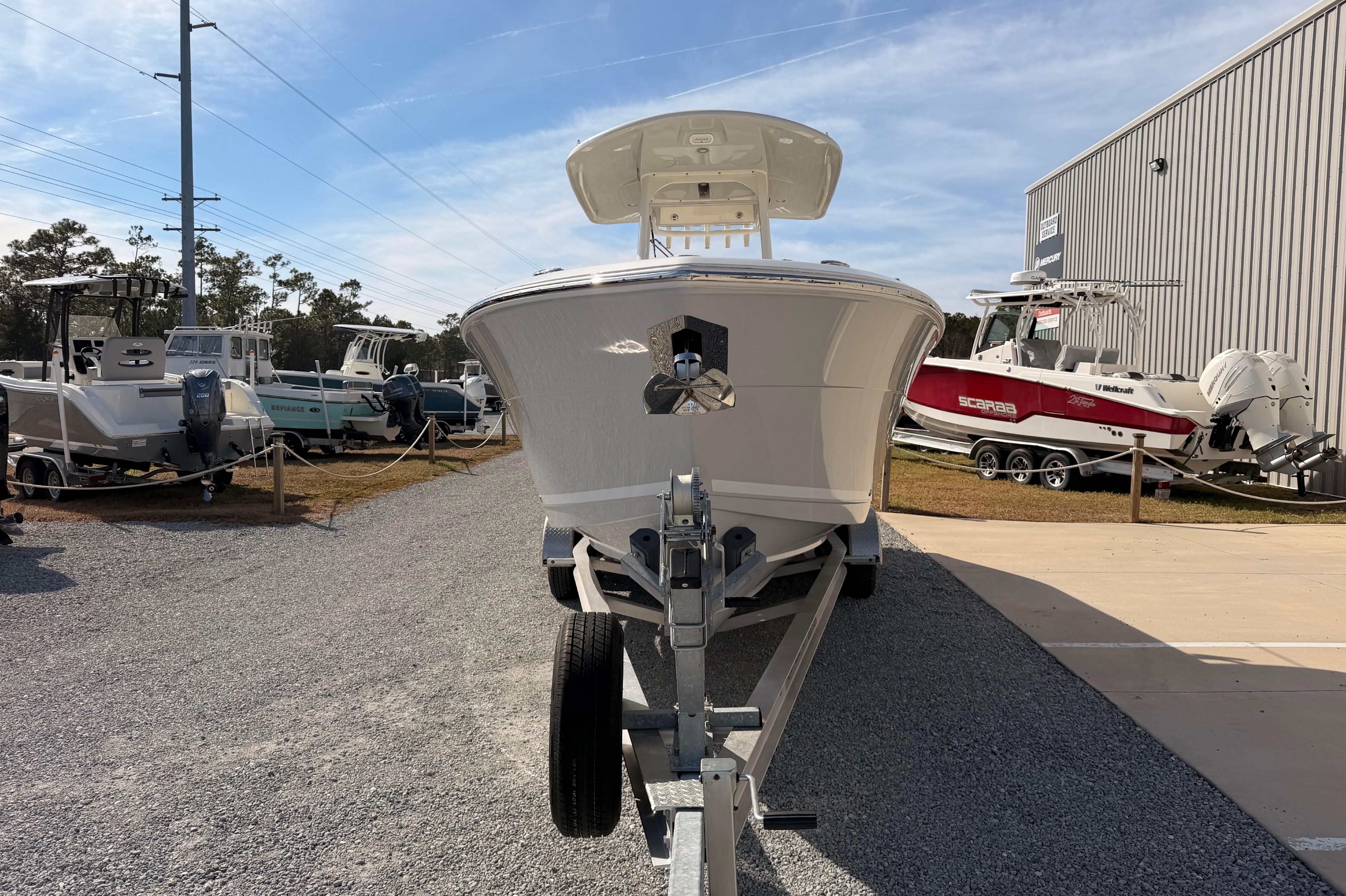 2024 Cobia 262 Center Console boat on trailer at dealership.