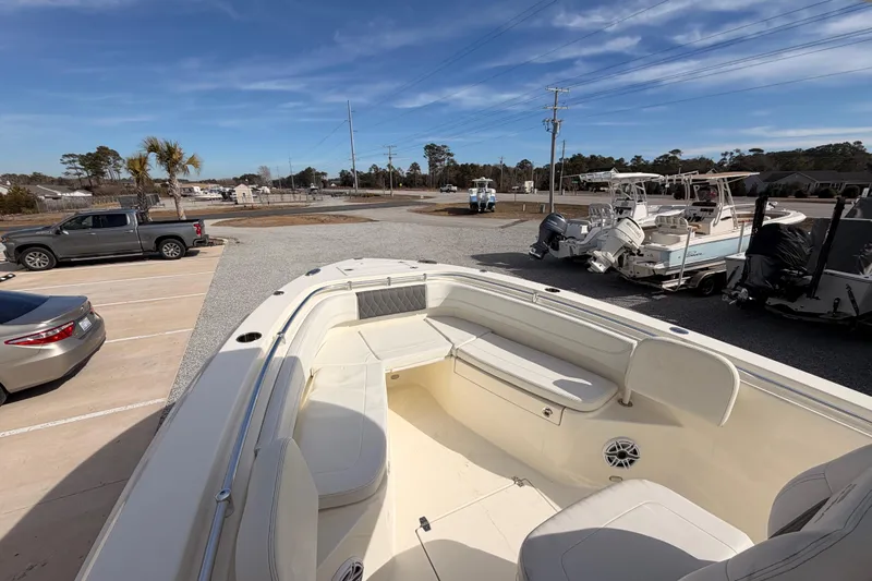  Yacht Photos Pics 2024 Cobia 262 Center Console boat in a parking lot with clear blue sky.