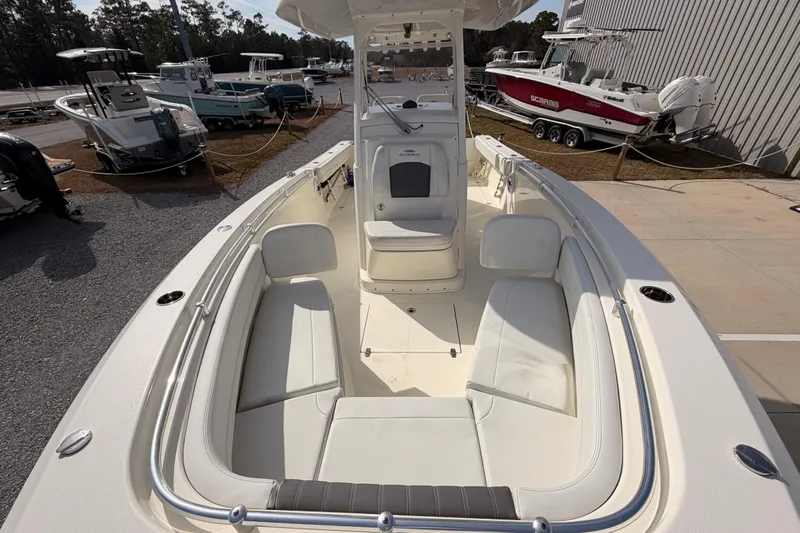  Yacht Photos Pics 2024 Cobia 262 Center Console boat with spacious seating, docked near other boats.