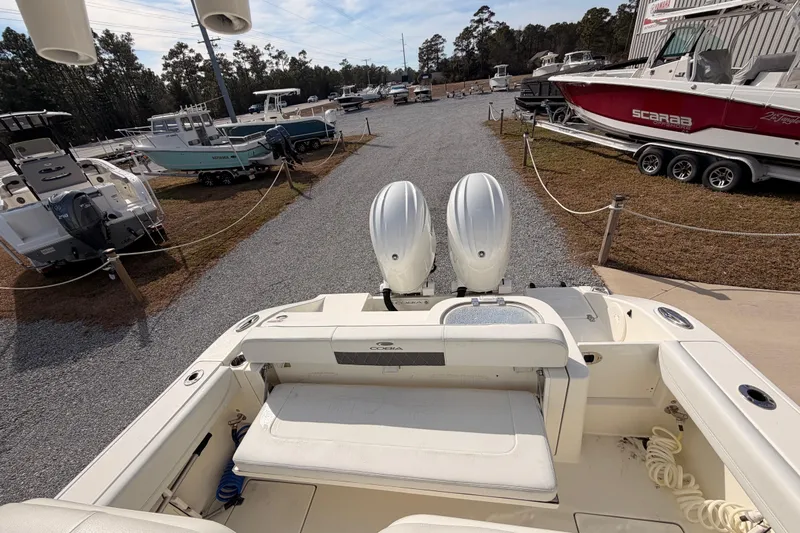 Yacht Photos Pics 2024 Cobia 262 Center Console boat with dual engines in a marina setting.