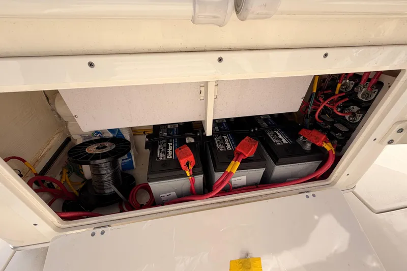  Yacht Photos Pics 2024 Cobia 262 Center Console battery compartment with wiring and components.