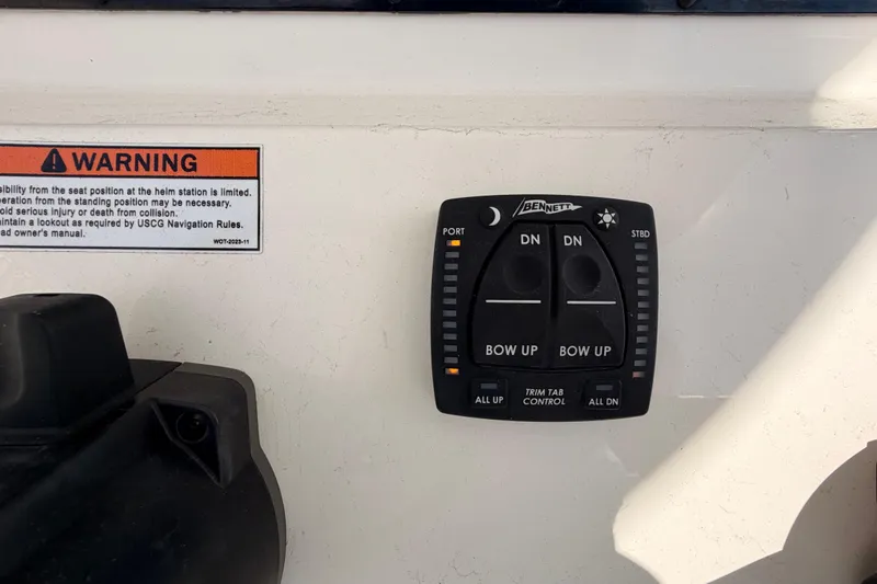  Yacht Photos Pics 2024 Cobia 262 Center Console trim tab control panel with warning label.