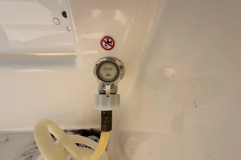  Yacht Photos Pics 2024 Cobia 262 Center Console raw water washdown outlet with hose attachment.