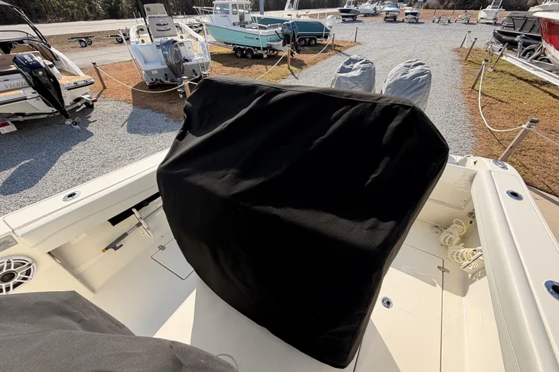  Yacht Photos Pics 2024 Cobia 262 Center Console boat interior with covered console, docked among other boats.