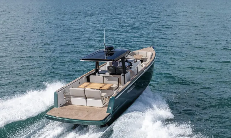  Yacht Photos Pics 2023 Fjord 38 motor yacht cruising on open water, showcasing sleek design and luxury features.