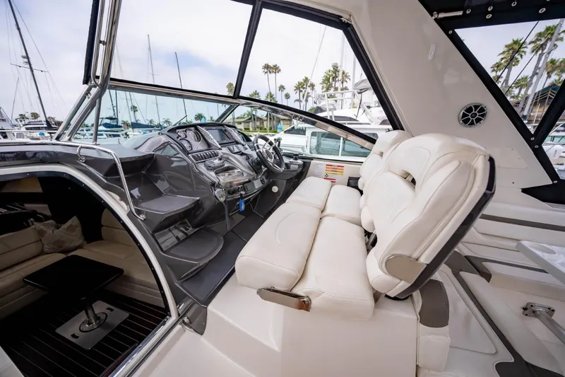 Memory Maker Yacht Photos Pics 2013 Monterey 340 Sport Yacht interior with helm, white seating, and marina view.