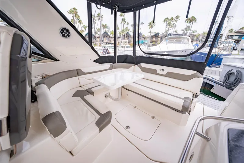 Memory Maker Yacht Photos Pics 2013 Monterey 340 Sport Yacht interior with plush seating and table, docked at marina.