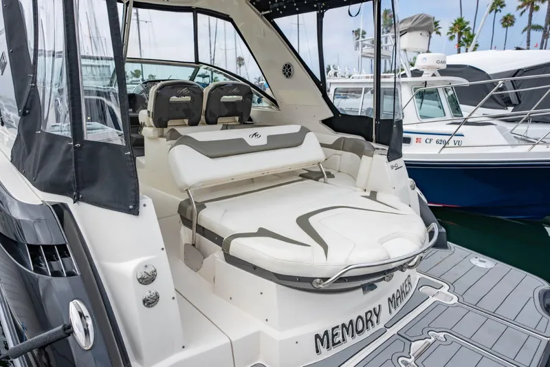Memory Maker Yacht Photos Pics 2013 Monterey 340 Sport Yacht with spacious seating, docked at a marina.