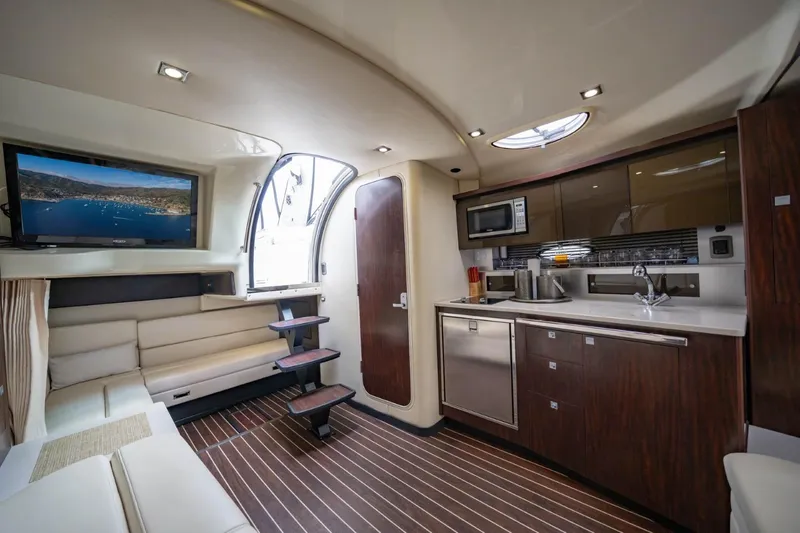 Memory Maker Yacht Photos Pics Luxurious interior of 2013 Monterey 340 Sport Yacht with modern kitchen and cozy seating area.