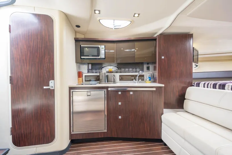 Memory Maker Yacht Photos Pics Luxurious interior of 2013 Monterey 340 Sport Yacht with modern kitchenette and seating.