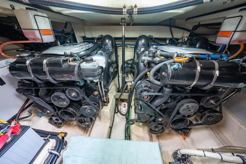 Memory Maker Yacht Photos Pics Engine room of a 2013 Monterey 340 Sport Yacht, showcasing dual engines and mechanical components.