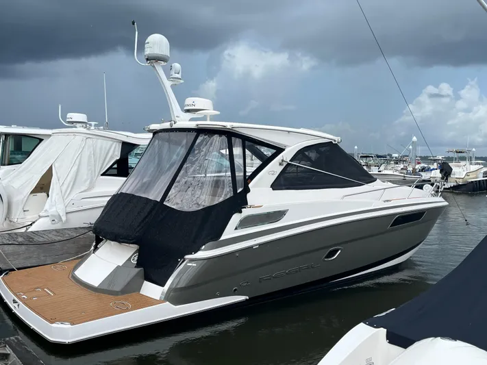  Yacht Photos Pics 2014 Regal 35 Sport Coupe docked at marina under cloudy sky.