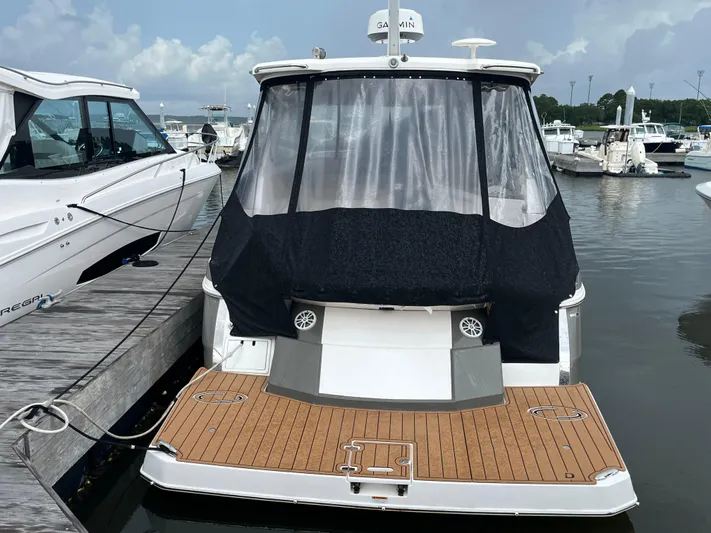  Yacht Photos Pics 2014 Regal 35 Sport Coupe docked at marina, rear view with covered deck.