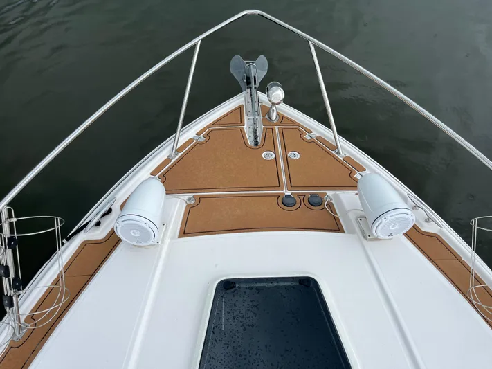  Yacht Photos Pics Bow of 2014 Regal 35 Sport Coupe with speakers and anchor, on calm water.