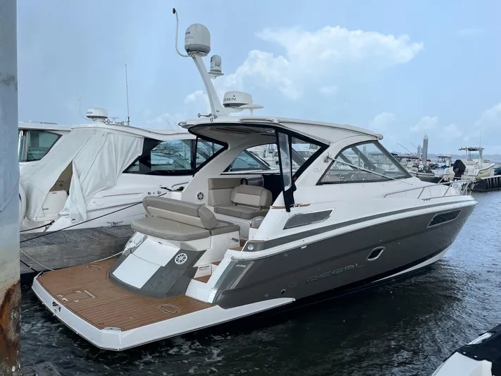  Yacht Photos Pics 2014 Regal 35 Sport Coupe yacht docked at marina, featuring sleek design and modern amenities.