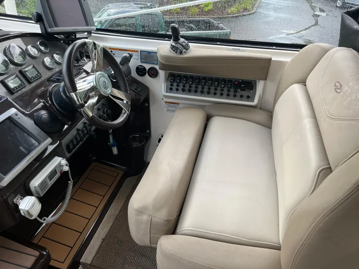  Yacht Photos Pics Interior cockpit of 2014 Regal 35 Sport Coupe with steering wheel and control panel.