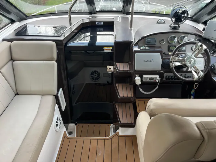  Yacht Photos Pics 2014 Regal 35 Sport Coupe cockpit with Garmin navigation and beige seating.