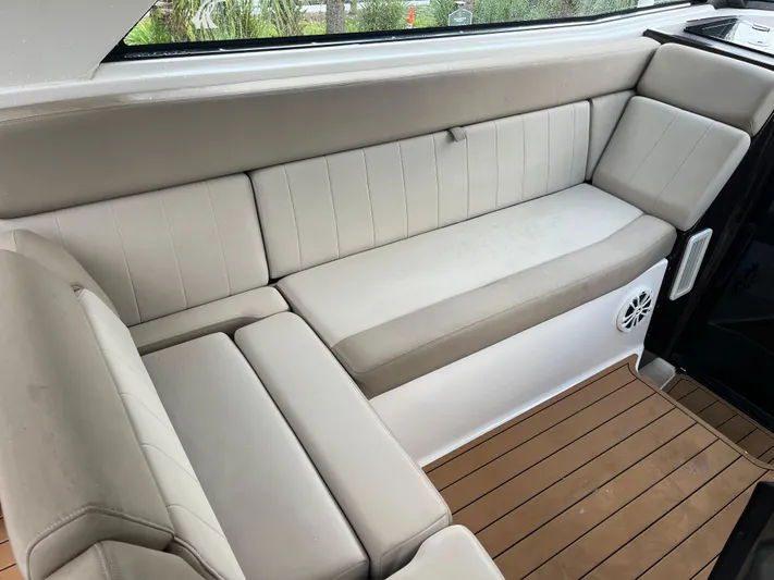  Yacht Photos Pics 2014 Regal 35 Sport Coupe interior with beige seating and wood flooring.