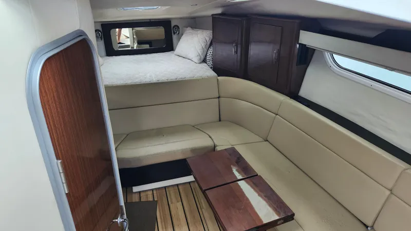  Yacht Photos Pics Interior of 2014 Regal 35 Sport Coupe with beige seating and wooden accents.