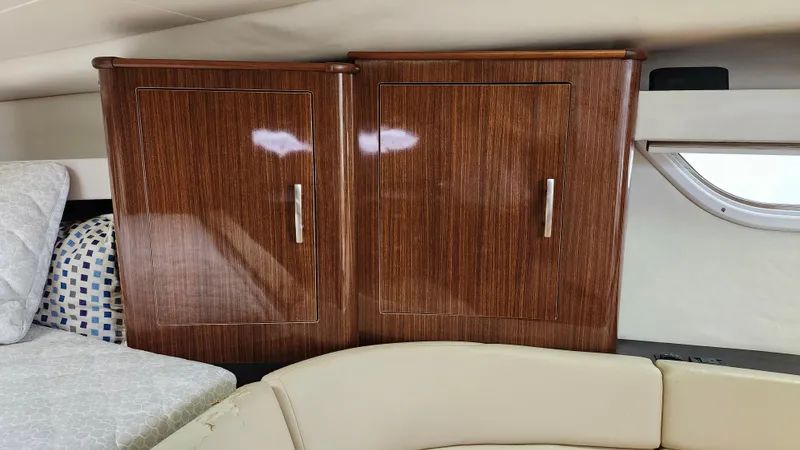  Yacht Photos Pics 2014 Regal 35 Sport Coupe interior with wooden cabinets and cozy seating.