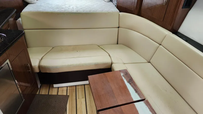  Yacht Photos Pics Interior of 2014 Regal 35 Sport Coupe with beige seating and wooden accents.
