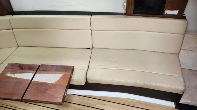  Yacht Photos Pics Beige leather seating and wooden table inside 2014 Regal 35 Sport Coupe boat.