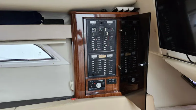  Yacht Photos Pics Electrical panel inside 2014 Regal 35 Sport Coupe boat cabin with wood finish.
