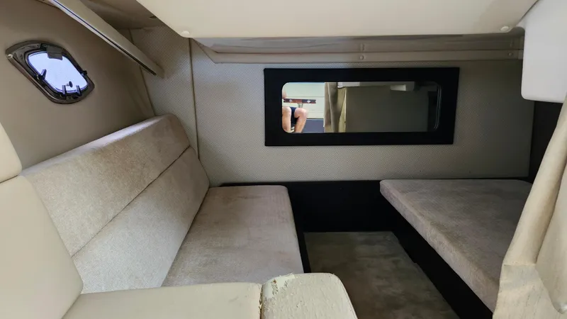  Yacht Photos Pics Interior cabin of 2014 Regal 35 Sport Coupe with beige seating and window.