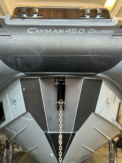  Yacht Photos Pics 2023 Cayman Yachts 45.0 Cruiser, sleek design, docked in a marina.