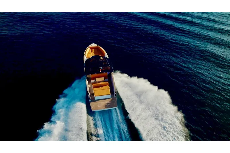 Quantum Yacht Photos Pics 2024 Tesoro T40 Inboard cruising on open water, aerial view.