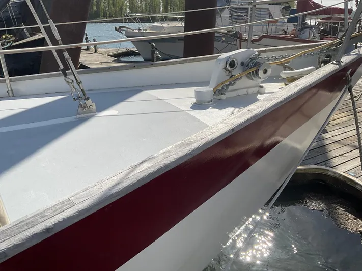  Yacht Photos Pics 1980 Kanter Staysail Cutter docked, showcasing deck and railing details.