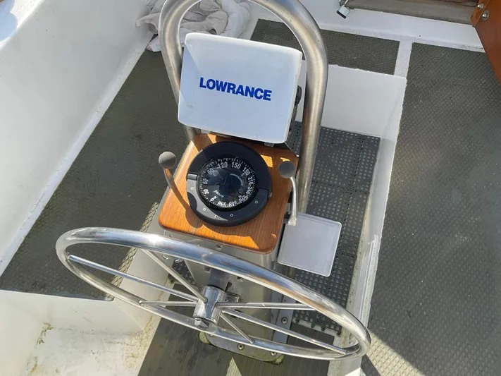  Yacht Photos Pics Steering wheel and compass on 1980 Kanter Staysail Cutter sailboat deck.