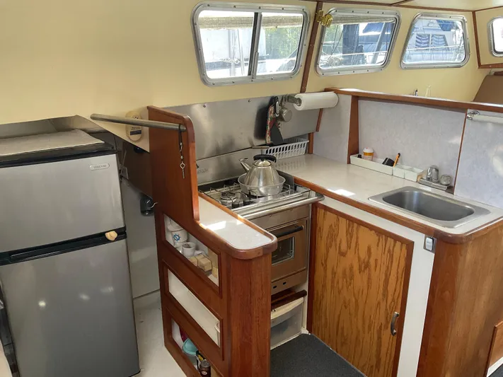  Yacht Photos Pics 1980 Kanter Staysail Cutter galley with stove, sink, and refrigerator.