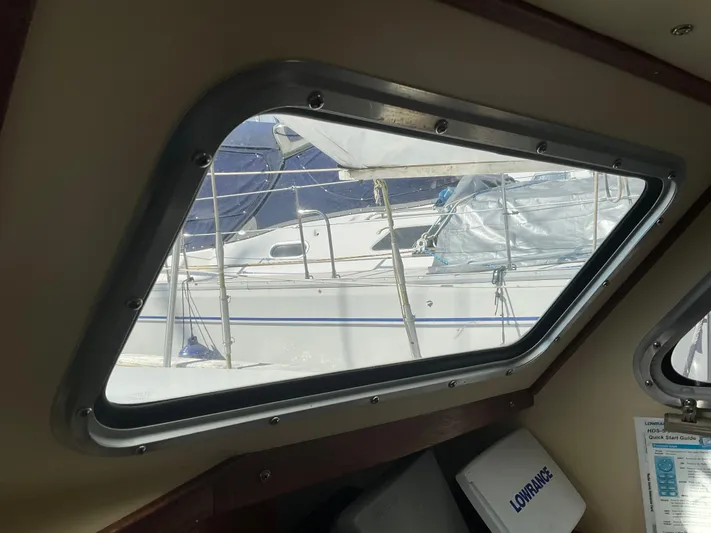  Yacht Photos Pics View from inside a 1980 Kanter Staysail Cutter, showing another sailboat through the window.