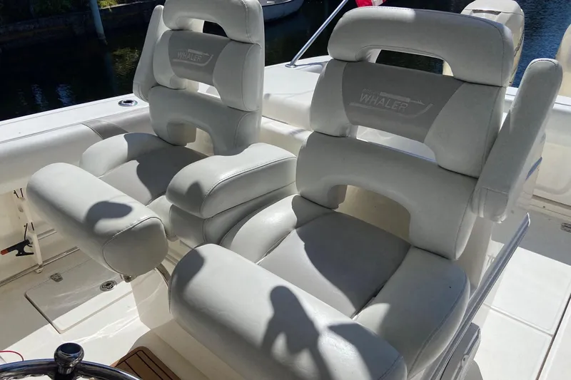  Yacht Photos Pics Luxury seating on a 2011 Boston Whaler 320 Outrage boat, featuring plush white upholstery.