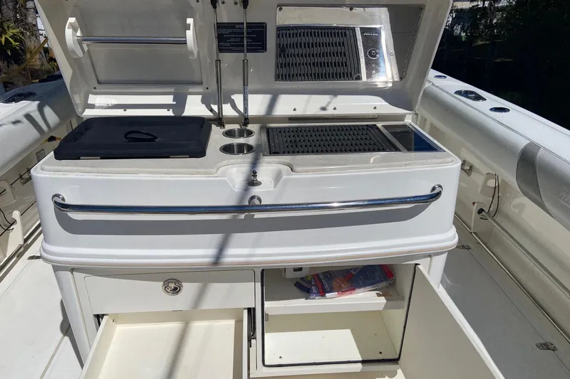  Yacht Photos Pics 2011 Boston Whaler 320 Outrage boat kitchen area with grill and storage compartments.