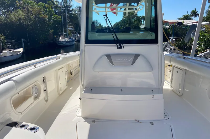  Yacht Photos Pics 2011 Boston Whaler 320 Outrage boat interior with seating and storage compartments.