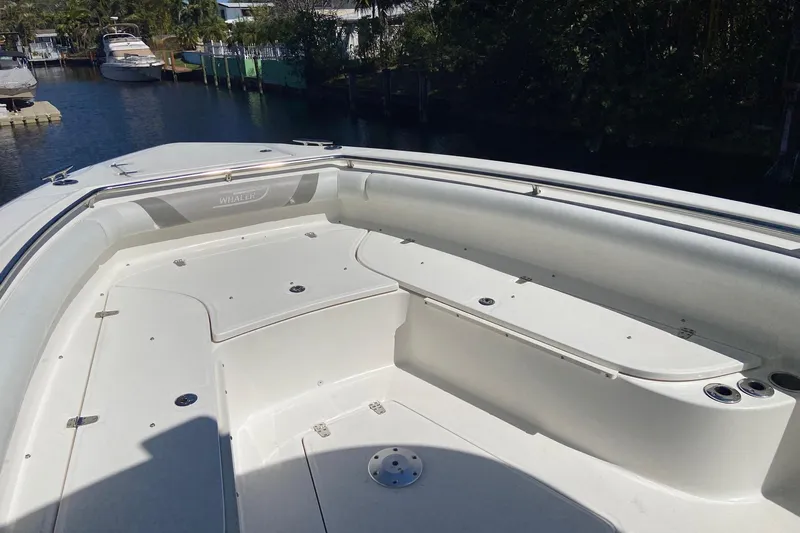  Yacht Photos Pics 2011 Boston Whaler 320 Outrage boat deck with seating and storage compartments.