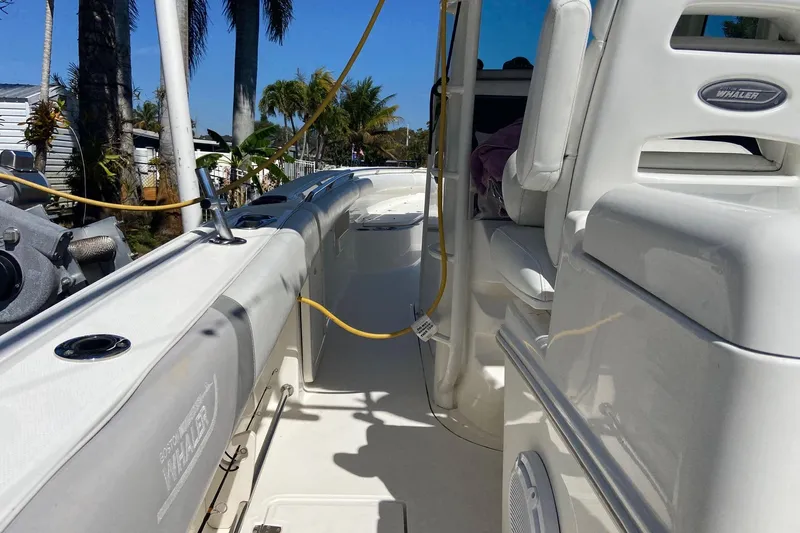  Yacht Photos Pics 2011 Boston Whaler 320 Outrage boat interior with seating and equipment, under sunny skies.