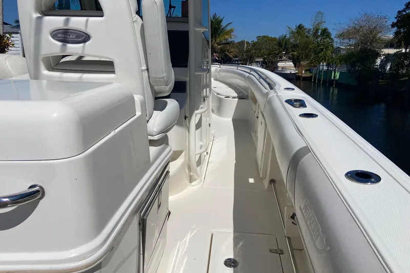  Yacht Photos Pics 2011 Boston Whaler 320 Outrage boat interior with white seating and sleek design.