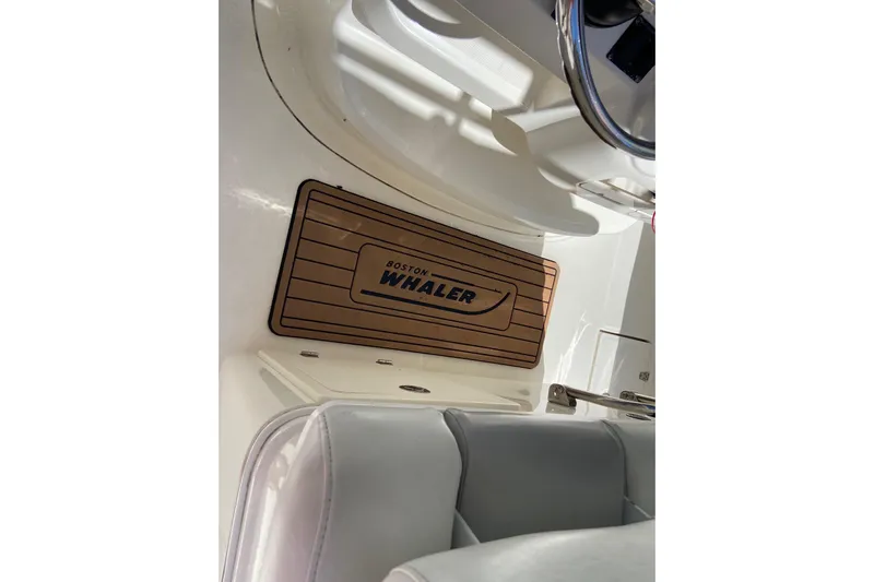  Yacht Photos Pics 2011 Boston Whaler 320 Outrage interior with branded floor mat and seating.