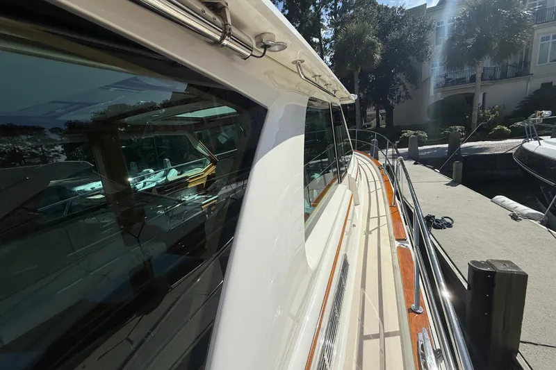 Strange Magic Yacht Photos Pics 2023 Sabre 43 Salon Express yacht docked, showcasing sleek design and reflective windows.