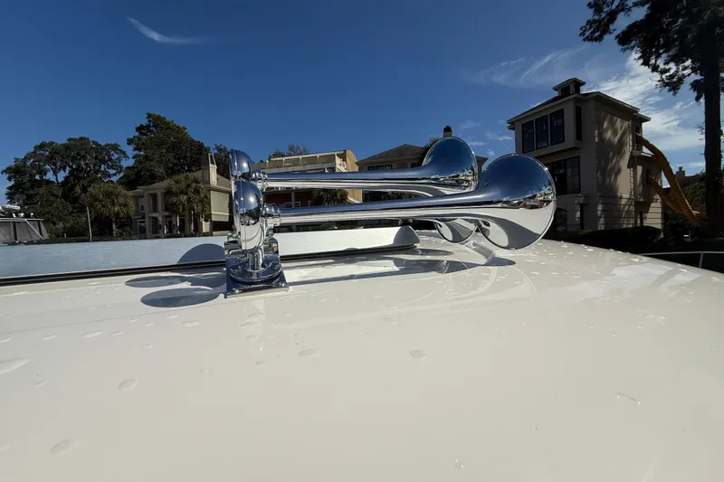 Strange Magic Yacht Photos Pics Chrome horns on 2023 Sabre 43 Salon Express yacht, sunny day, residential backdrop.